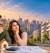 Affordable homes in India featuring a young couple reviewing property plans, with modern residential apartments and high-rise buildings in the background.