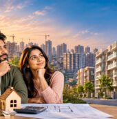 Affordable homes in India featuring a young couple reviewing property plans, with modern residential apartments and high-rise buildings in the background.