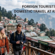 Crowded hill-station street with domestic and foreign tourists, mountain views, and colonial buildings. Text overlay reads, “Foreign Tourists Down, Domestic Travel at Record High.”