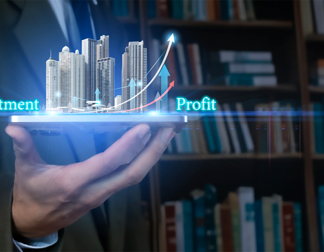 Hand holding a tablet displaying a digital real estate investment concept, with high-rise buildings, rising arrows, and the words “Investment” and “Profit.”